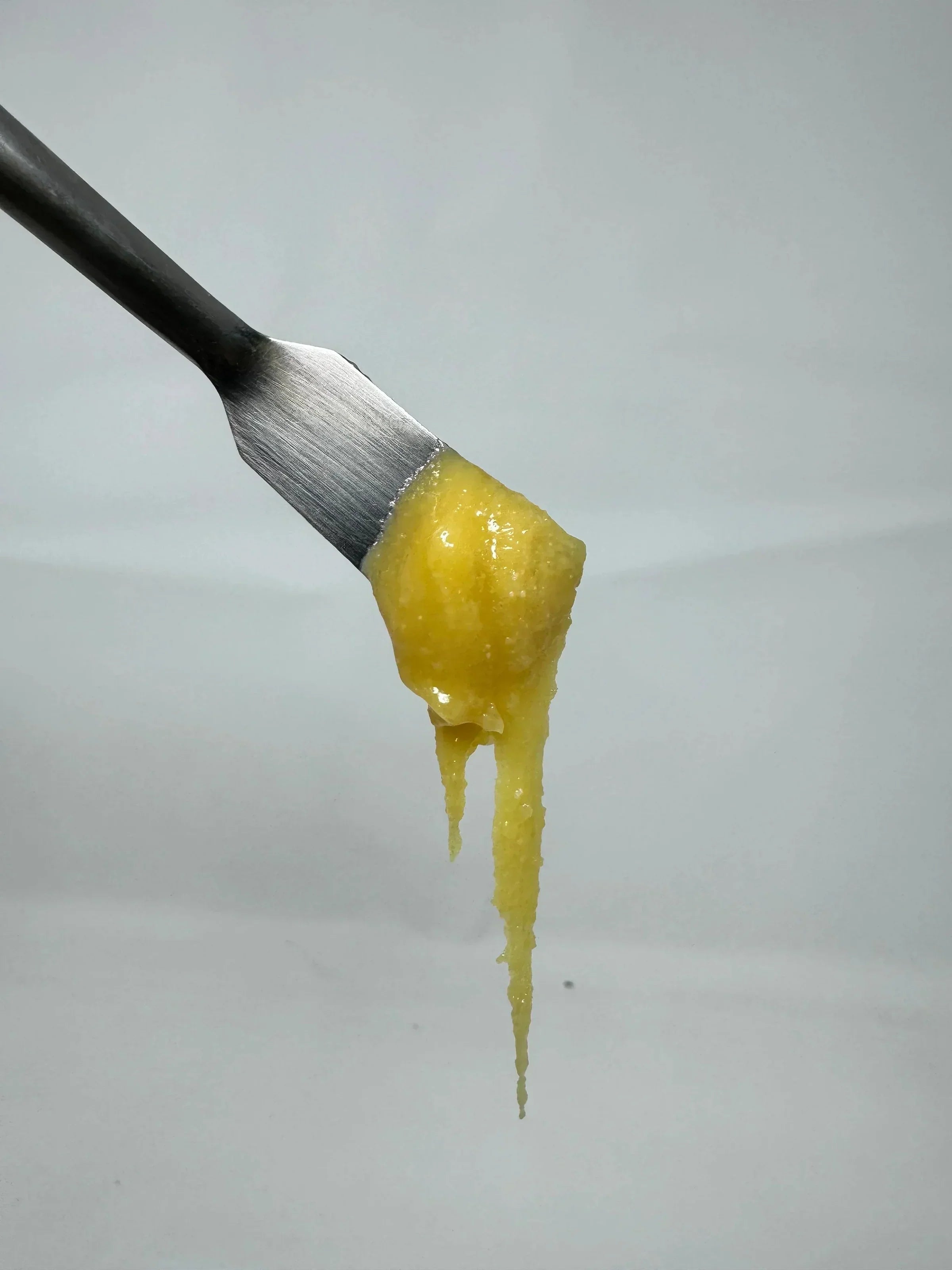 An image of a large scoop of THCa badder on a silver dabbing tool. Learn about THC concentrates, including this badder, in this blog from NOVA Hemp.