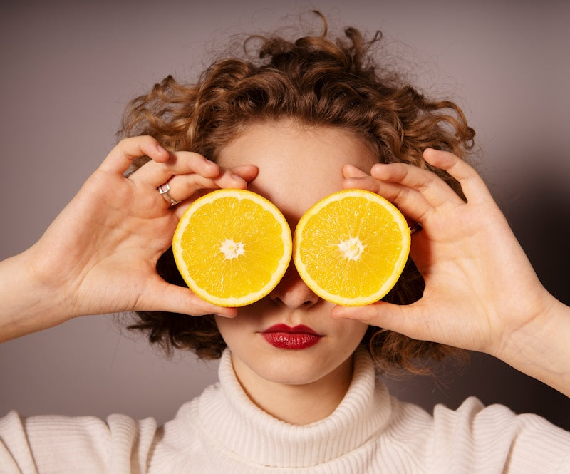 woman, curly hair, oranges, red lipstick