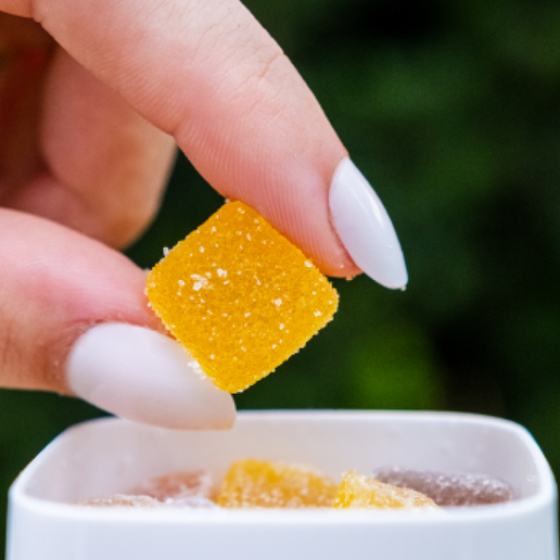 Canned Nova Hemp Root Beer with 2mg THC, surrounded by colorful candies and LittiPops packaging.