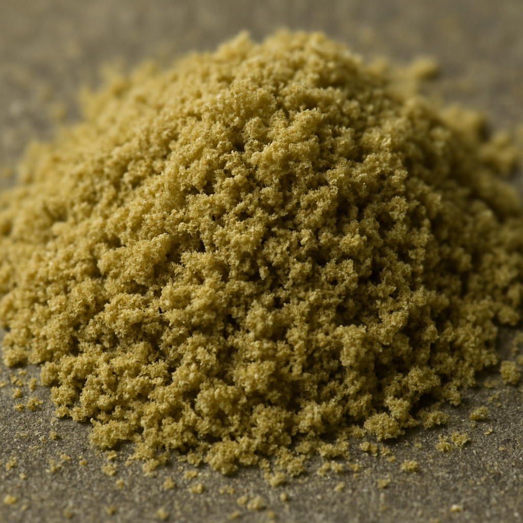 Close-up image of premium golden THCa kief from Nova Hemp, highlighting finely sifted cannabis trichomes with a rich, powdery texture on a clean neutral background.