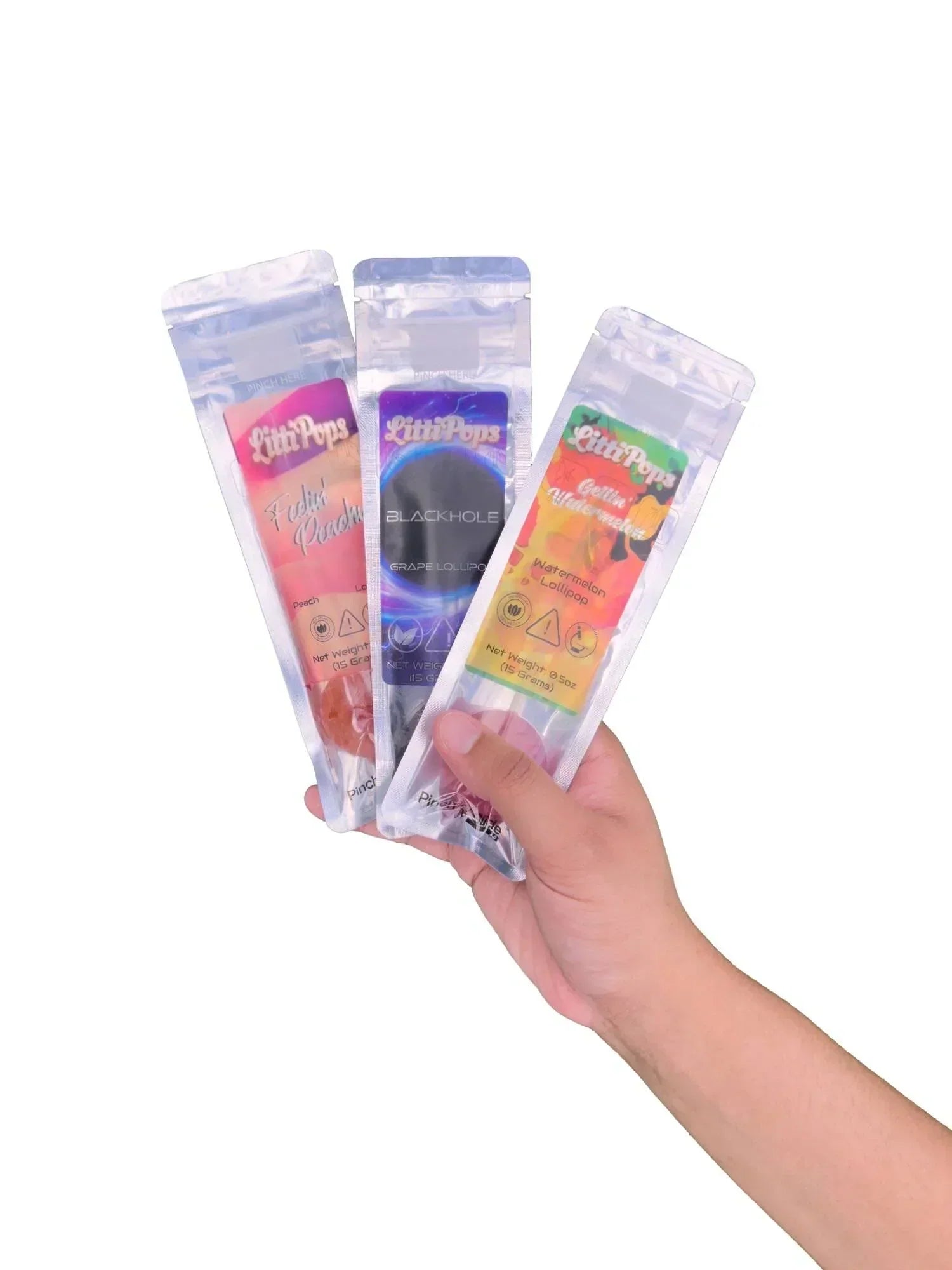 An image of a hand holding three flavors of NOVA Hemp THC lollipops.